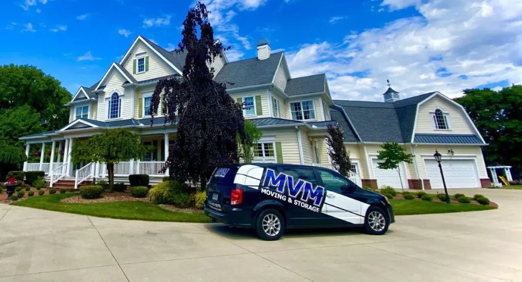 MVM Moving van outside a yellow house, helping to prep for a move