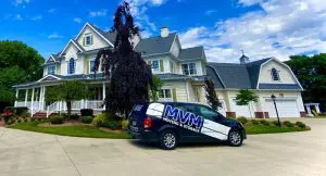 MVM Moving van outside a yellow house, helping to prep for a move